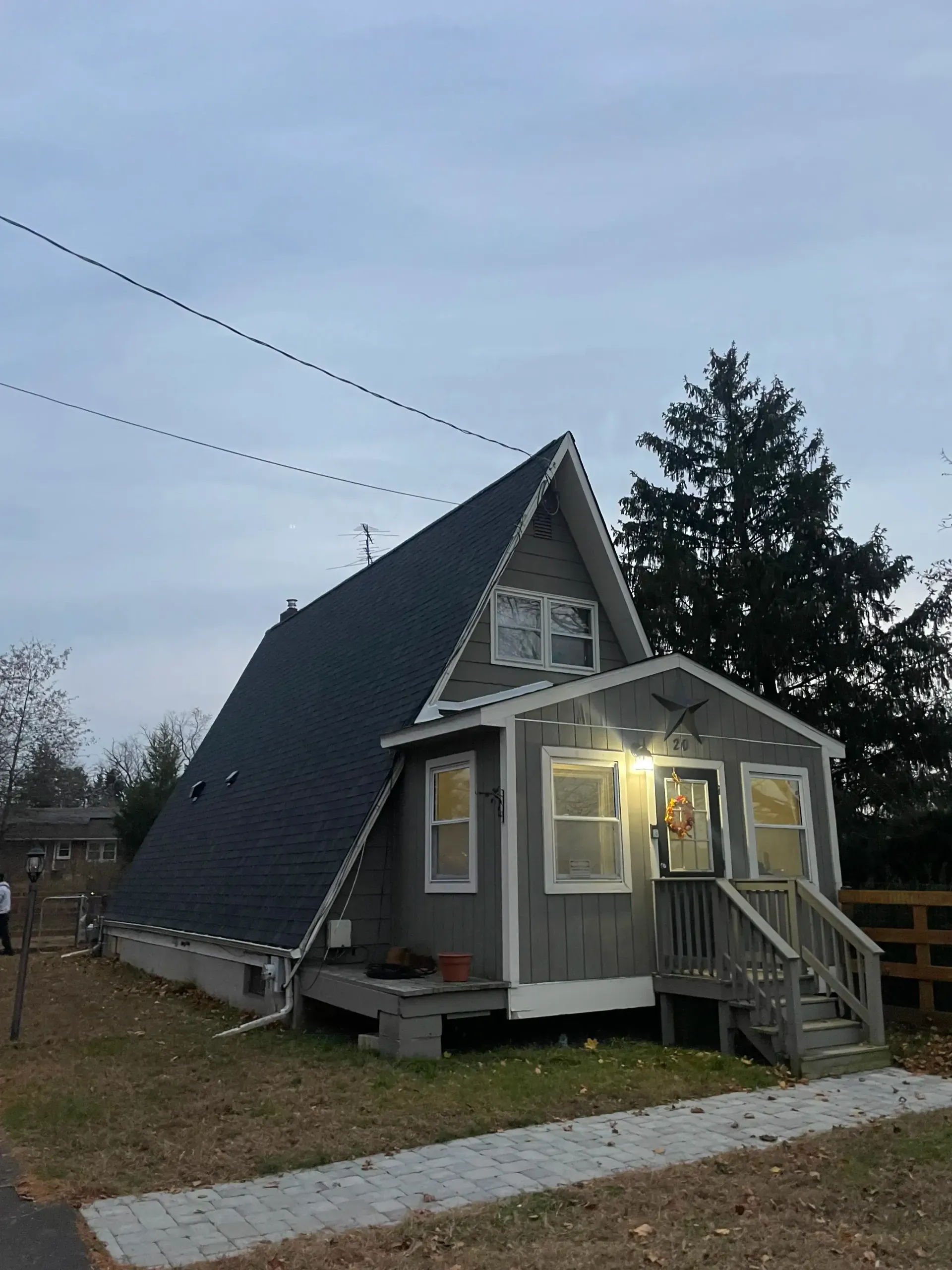 Home in Franklinville, NJ with a new roof installed by BE Roofing at dusk